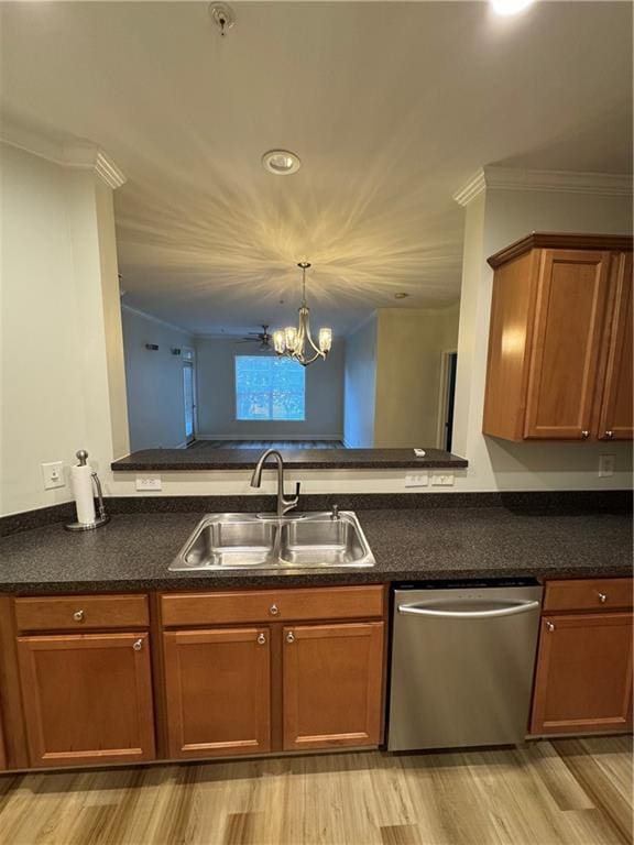 kitchen featuring crown molding, dark countertops, stainless steel dishwasher, brown cabinetry, and a sink