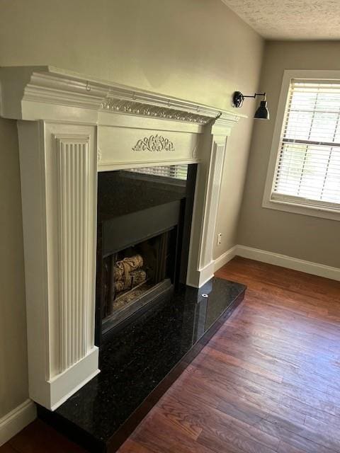 interior details featuring hardwood / wood-style floors and a textured ceiling