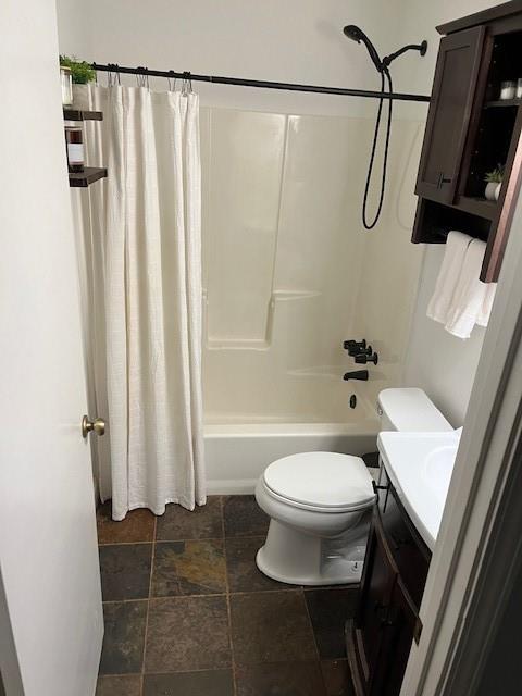 full bathroom featuring shower / tub combo with curtain, vanity, and toilet