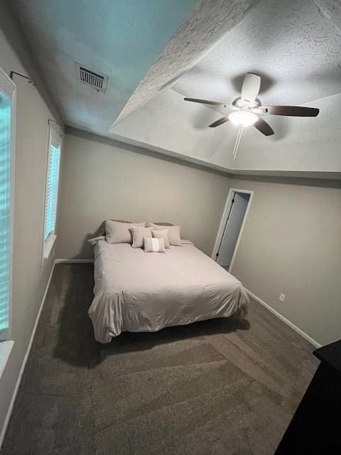 carpeted bedroom featuring a textured ceiling and ceiling fan