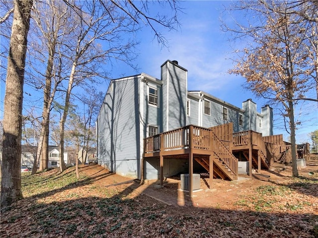 rear view of property with a wooden deck and central air condition unit