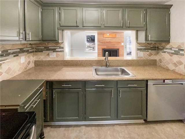 kitchen featuring tasteful backsplash, appliances with stainless steel finishes, sink, and green cabinetry