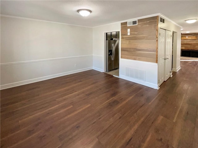 unfurnished room with crown molding and dark hardwood / wood-style floors