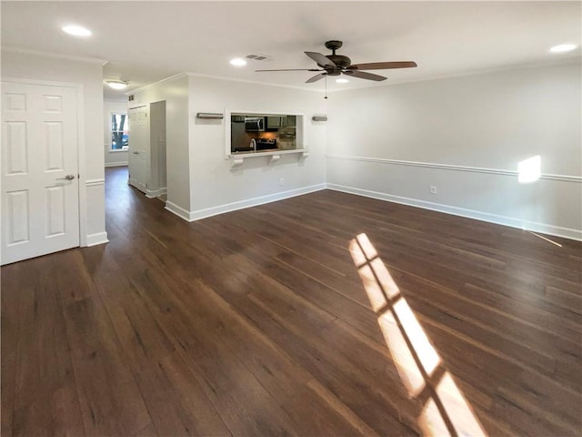 unfurnished living room featuring dark wood-type flooring and ceiling fan