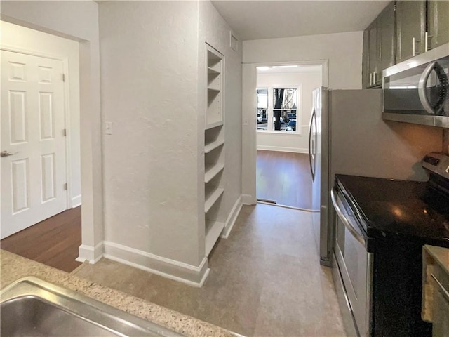 kitchen featuring gray cabinetry, hardwood / wood-style flooring, and appliances with stainless steel finishes