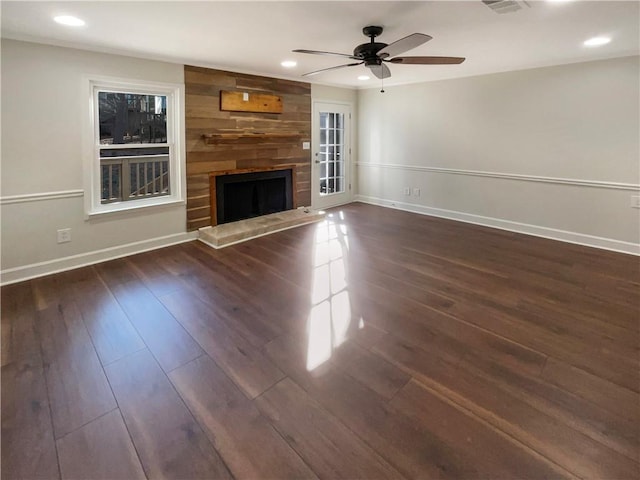 unfurnished living room with dark hardwood / wood-style flooring, a fireplace, and ceiling fan