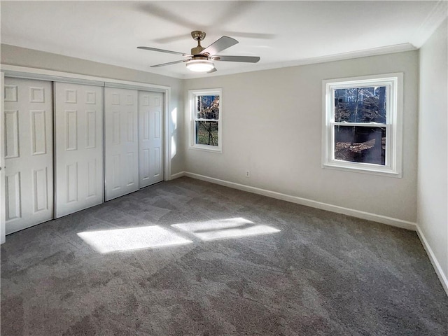 unfurnished bedroom with ceiling fan, carpet flooring, and a closet