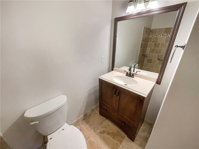 bathroom featuring vanity, tile patterned floors, and toilet