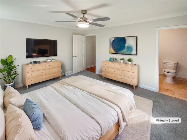 bedroom featuring ceiling fan, connected bathroom, and dark colored carpet