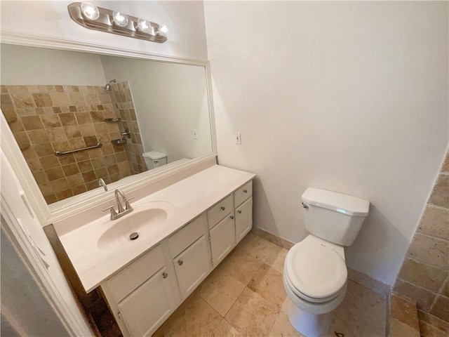 bathroom featuring vanity, toilet, and a shower