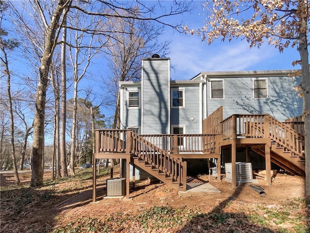 back of house with a deck and central air condition unit