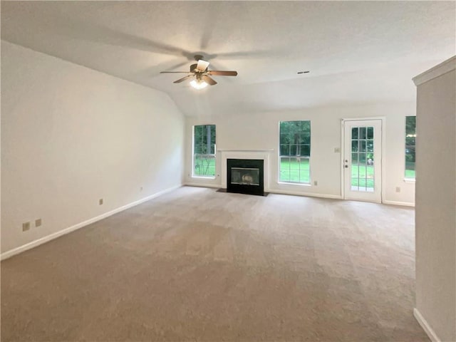 46 Timber Walk Dr, Sharpsburg, GA 30277 - unfurnished living room featuring carpet flooring, a ceiling fan, a fireplace with flush hearth, and vaulted ceiling