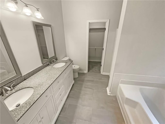 46 Timber Walk Dr, Sharpsburg, GA 30277 - bathroom featuring a spacious closet, a garden tub, double vanity, and tile patterned flooring