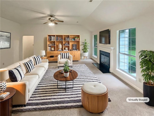 46 Timber Walk Dr, Sharpsburg, GA 30277 - living area featuring ceiling fan, a fireplace with flush hearth, vaulted ceiling, and carpet flooring