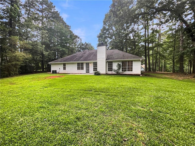 46 Timber Walk Dr, Sharpsburg, GA 30277 - back of house with a chimney and a yard