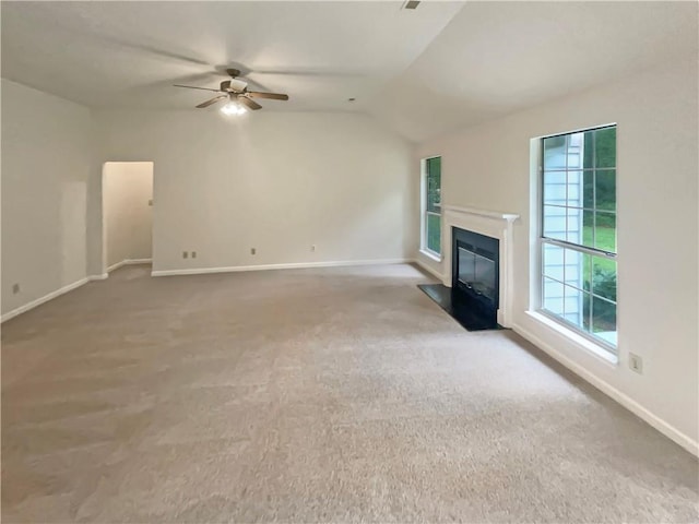46 Timber Walk Dr, Sharpsburg, GA 30277 - unfurnished living room with carpet flooring, a ceiling fan, a fireplace with flush hearth, and vaulted ceiling