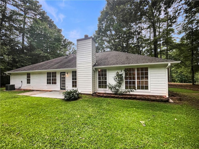 46 Timber Walk Dr, Sharpsburg, GA 30277 - back of property featuring a chimney, a patio area, and a lawn