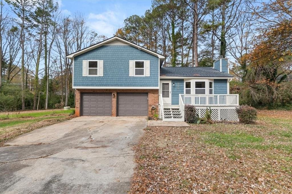 split level home with covered porch and a garage