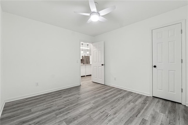 unfurnished room featuring light wood-type flooring and ceiling fan