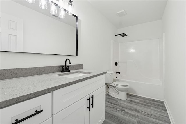 full bathroom with vanity, toilet, shower / bath combination, and wood-type flooring