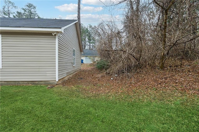 view of side of property featuring a yard