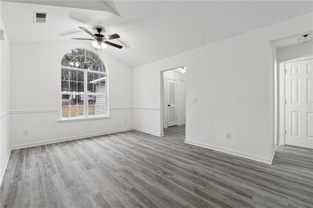 unfurnished room featuring vaulted ceiling, dark wood-type flooring, and ceiling fan