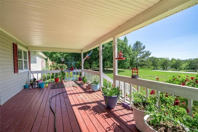 deck featuring a porch and a lawn