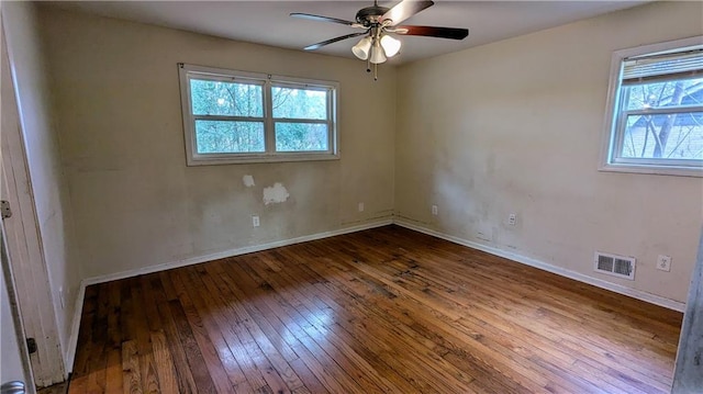 unfurnished room with dark hardwood / wood-style flooring, plenty of natural light, and ceiling fan