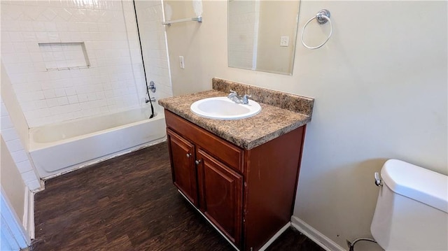 full bathroom with shower / bath combination, vanity, wood-type flooring, and toilet