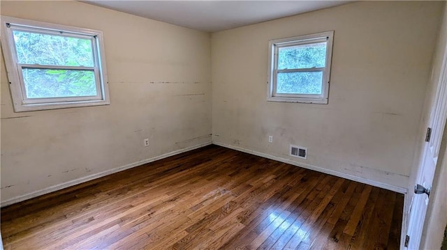 unfurnished room with dark hardwood / wood-style floors