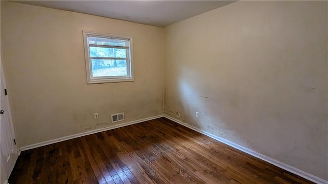 empty room with dark hardwood / wood-style floors