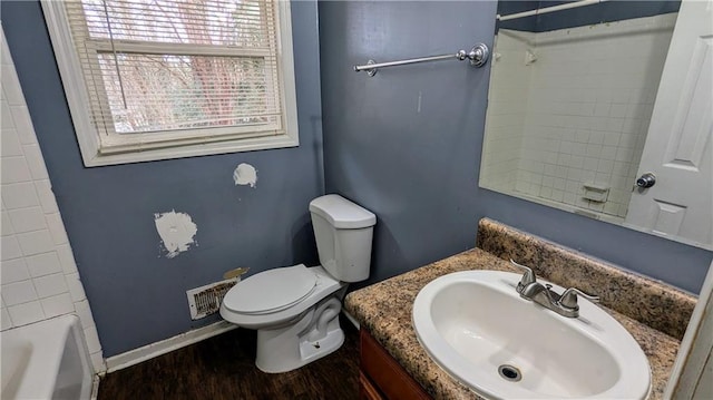 bathroom with toilet, vanity, and hardwood / wood-style flooring