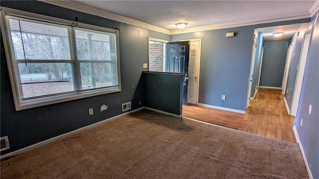 interior space featuring wood-type flooring, plenty of natural light, and crown molding