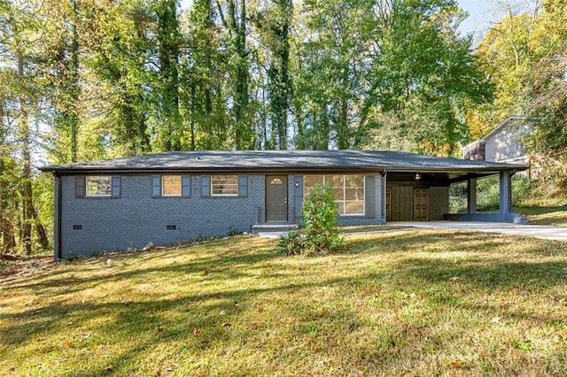 view of front of house with concrete driveway, an attached carport, crawl space, a front lawn, and brick siding