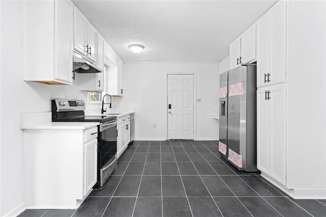 kitchen with under cabinet range hood, white cabinetry, stainless steel appliances, and light countertops