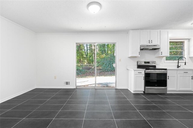 kitchen featuring under cabinet range hood, electric range, dark tile patterned floors, a sink, and white cabinetry