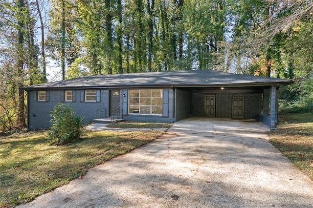 view of front of property with an attached carport, a front lawn, concrete driveway, and brick siding