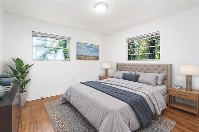 bedroom with wood finished floors and baseboards