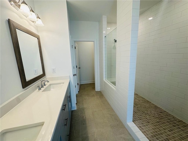 bathroom featuring vanity and tiled shower