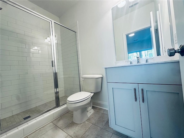 bathroom featuring walk in shower, tile patterned flooring, vanity, and toilet