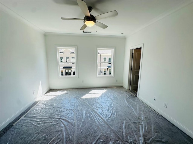 unfurnished room with ceiling fan and ornamental molding