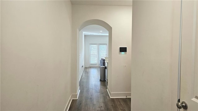 hallway with dark hardwood / wood-style flooring