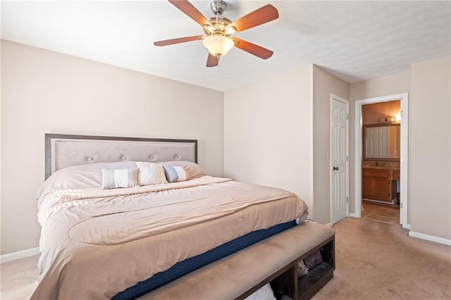 bedroom with a ceiling fan, light colored carpet, and baseboards