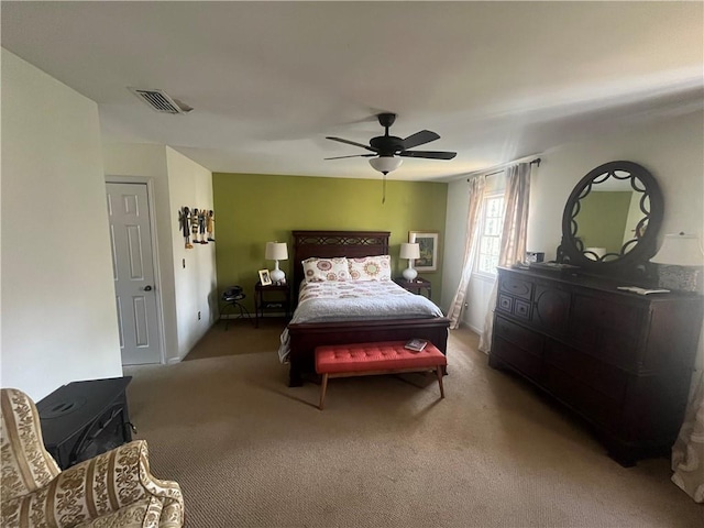 bedroom with visible vents, carpet floors, and a ceiling fan