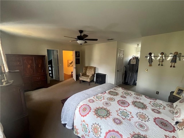 bedroom featuring visible vents, a ceiling fan, and carpet floors