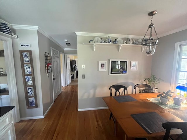 dining space with crown molding, dark wood-type flooring, and baseboards