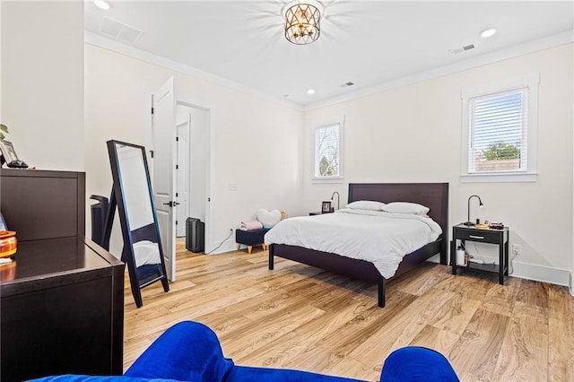 bedroom featuring light hardwood / wood-style flooring and ornamental molding