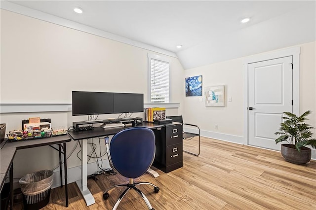 office space with vaulted ceiling and light hardwood / wood-style floors