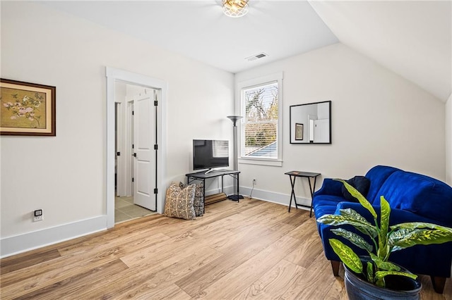 sitting room with vaulted ceiling and hardwood / wood-style floors