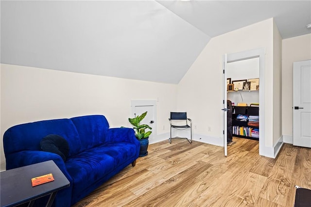 living area featuring light wood-type flooring and lofted ceiling